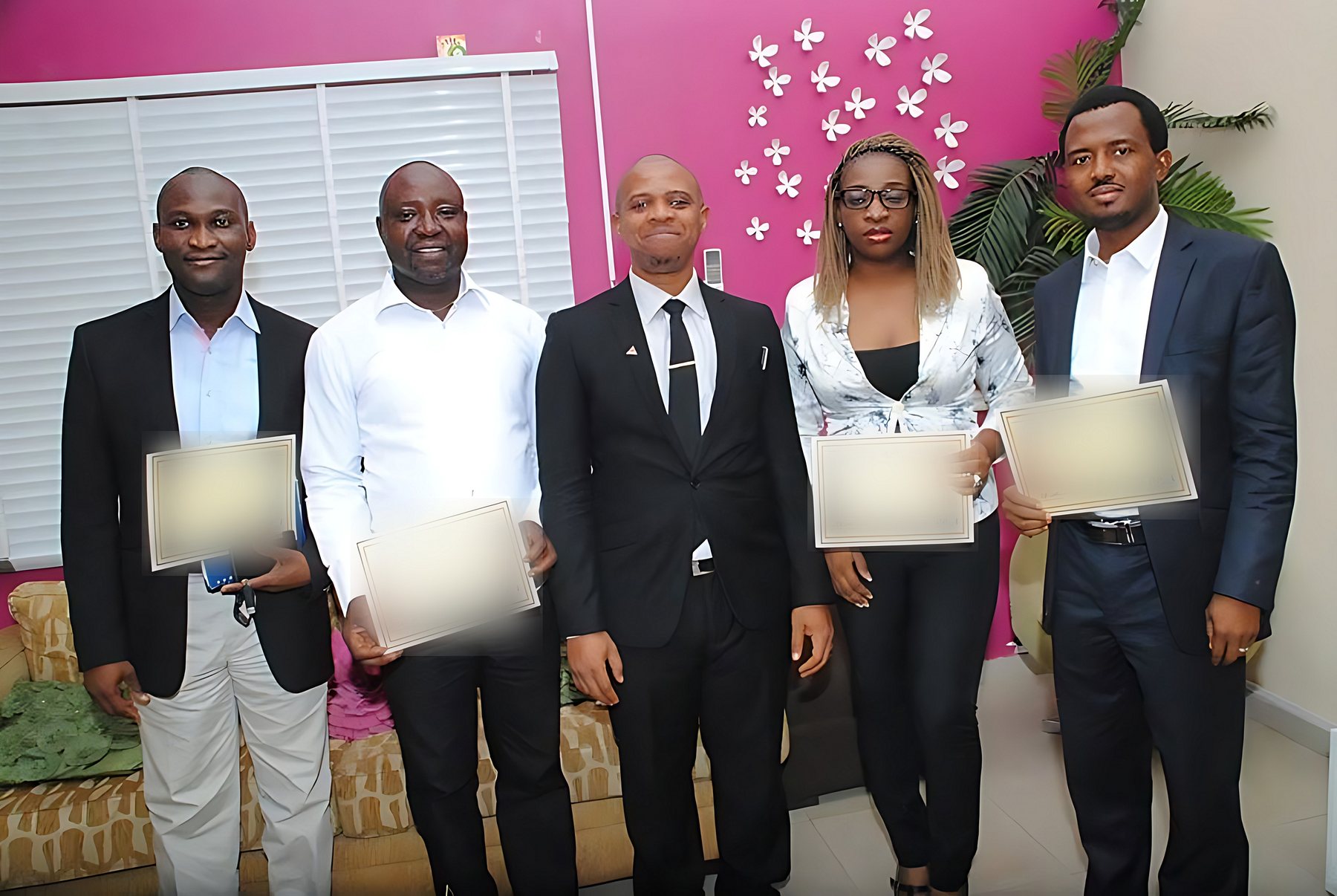 Chuba Nkala with four course participants holding certificates